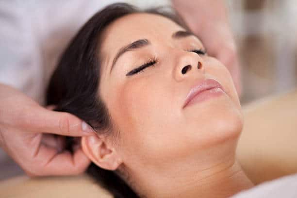 Auriculotherapy Ear Massage Woman receiving ear massage